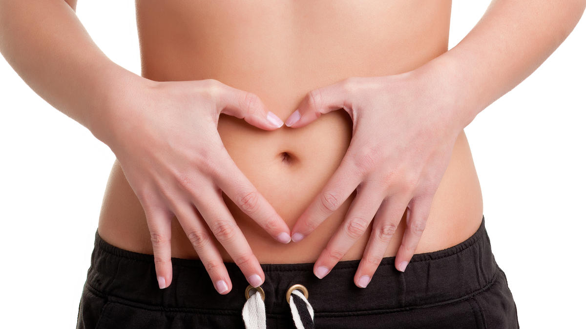 Hands forming a heart on abdomen, showing digestive wellness and colon hydrotherapy benefits in Tempe at Amber Colonics.