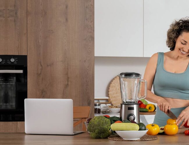 Woman preparing fresh vegetables in a kitchen as part of a clean colon diet for natural detox and digestive health.