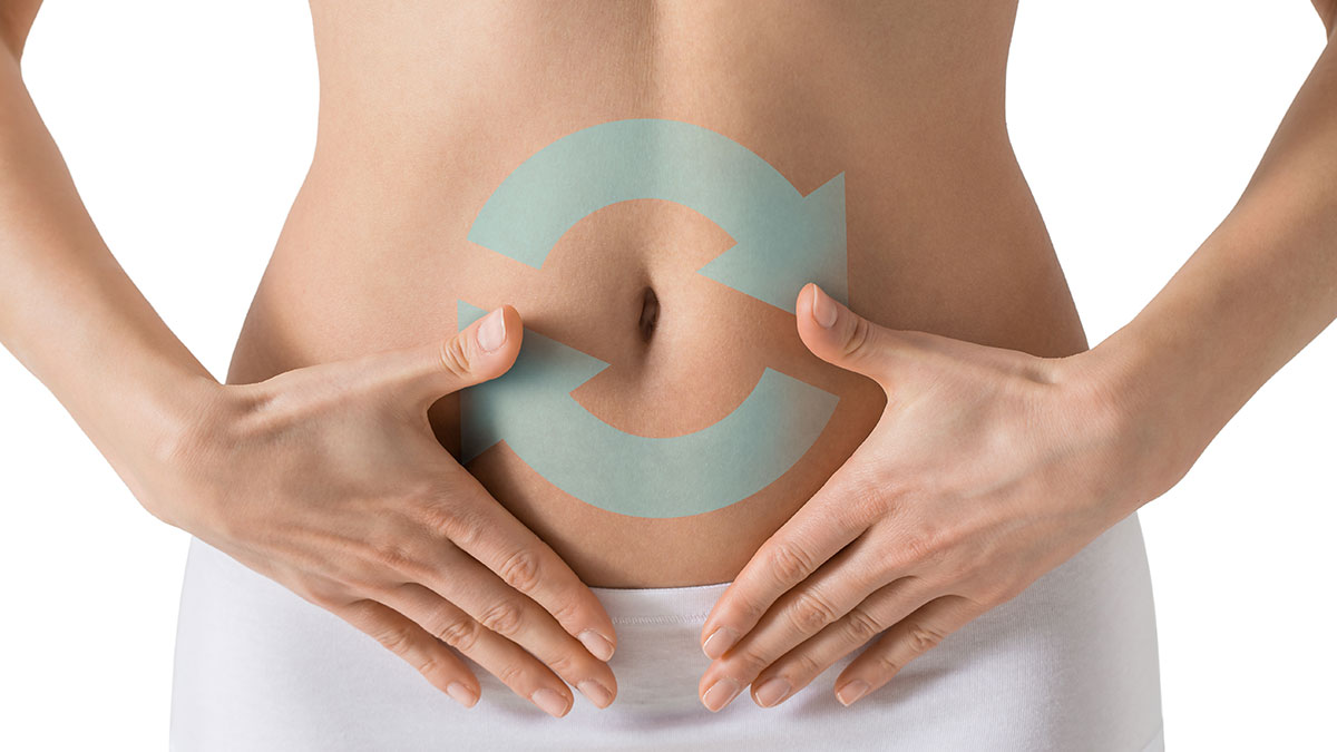 Close up of a woman’s abdomen with refresh symbol overlay representing digestive balance and colon health in an article on colonics vs enemas vs laxatives